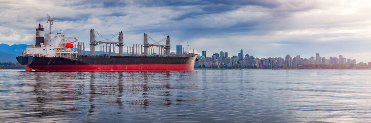 Container Ship in Burrard Inlet with Downtown City in Background. Vancouver, BC, Canada