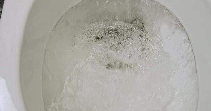 Flush water in toilet. Cut hair, get rid of it, wash it down drain. Close-up. Concept of home haircut will get rid of the trash.