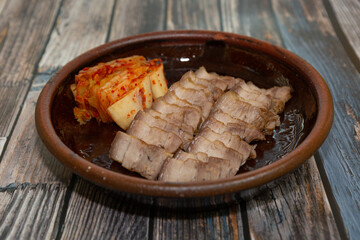 Kimchi, a traditional Korean fermented food. A plate of boiled pork served with traditional kimchi.