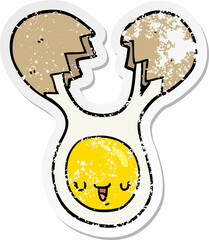 distressed sticker of a cartoon cracked egg