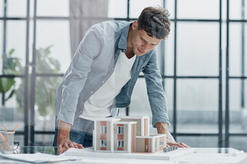 male architect designer examines the layout of the house. new project