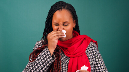 Sick woman wipes nose with tissue, cold and flu over Christmas festive season