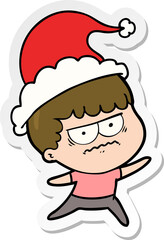 hand drawn sticker cartoon of a annoyed man wearing santa hat