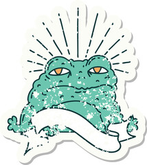 worn old sticker of a tattoo style toad character