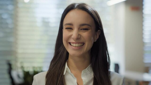 Happy business office worker student girl smiling wide sincere laughing humorous reaction fun looking at camera businesswoman Caucasian female employer woman laugh joke humor ridiculous manager funny