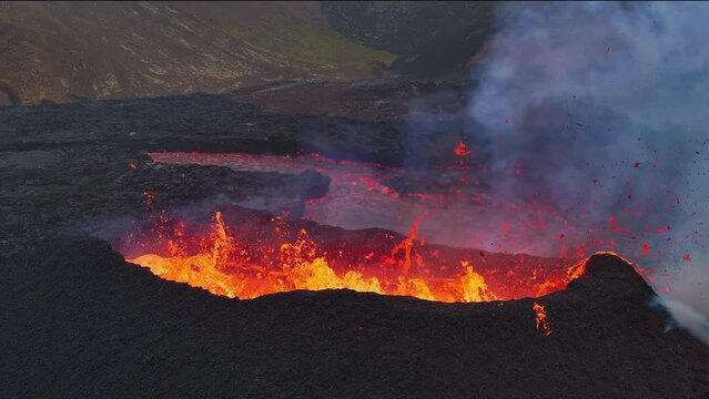 Close up view of active volcanic crater eruption. Hot lava and magma splashing out of crater. Tourist attraction in Iceland Litli-Hrútur eruption 2023. Beautiful and dangerous disaster.