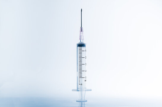 Macro syringe,A 5ml syringe and needle isolated on a white background with detailed clipping path,Close up of a syringe. Focus on numbers