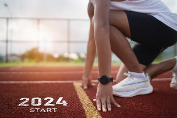 Happy new year 2024 Sport man runner running into the new year 2024. Start up of close up foot shoes jogging at stadium go to Goal of Success. Runner running Start to goal to success.