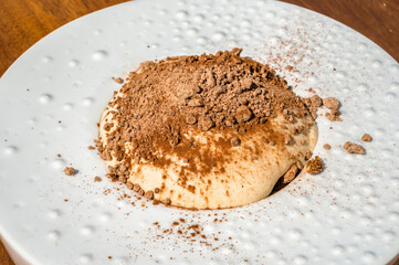 Mouse-shaped chocolate dessert adorned with meticulously arranged chocolate peels on top. Perfect for confectionery promotions, dessert menus, or any project 