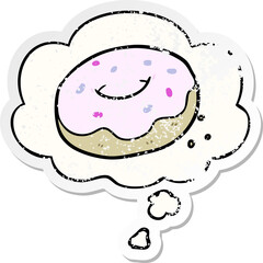 cartoon donut with thought bubble as a distressed worn sticker