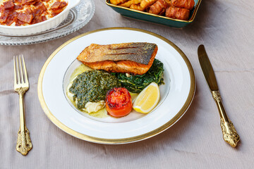Grilled Salmon Steak with Spinach and Lemon Wedges..Grilled Salmon Steak with Spinach and Lemon Wedges.