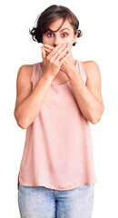 Beautiful young woman with short hair wearing casual style with sleeveless shirt shocked covering mouth with hands for mistake. secret concept.