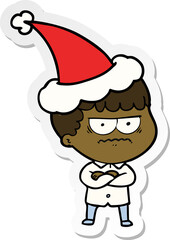 hand drawn sticker cartoon of an annoyed man wearing santa hat