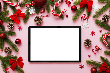 Fototapeta na wymiar Top view of empty tablet on Christmas background made of new year decorand festive decorations. New year holiday concept. Mockup