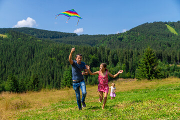 A family flies a kite in nature. Selective focus.