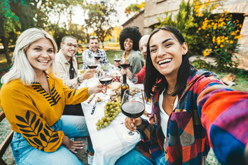 Happy friends having bbq dinner party in garden restaurant - Group of young people taking selfie picture sitting at dining table - Life style concept with guys and girls enjoying picnic together