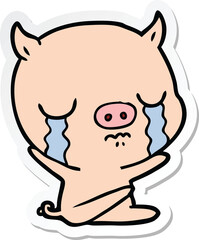 sticker of a cartoon sitting pig crying