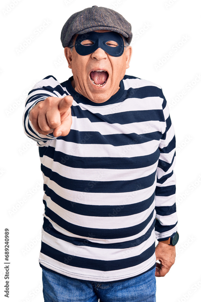 Sticker senior handsome man wearing burglar mask and t-shirt pointing displeased and frustrated to the camer