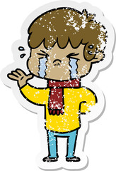 distressed sticker of a cartoon boy crying