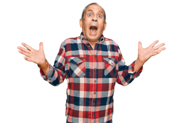 Senior hispanic man wearing casual clothes celebrating victory with happy smile and winner expression with raised hands