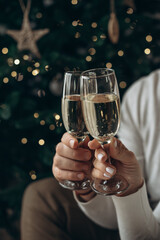 A man and a woman are holding glasses of champagne. Christmas, New year.