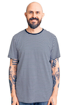 Young handsome man wearing casual clothes with a happy and cool smile on face. lucky person.