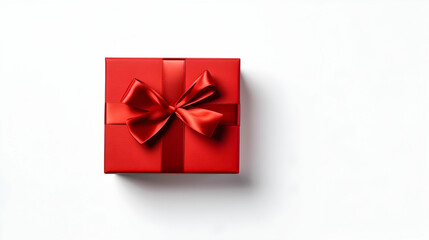 Red gift box with ribbon on white. Copy space.