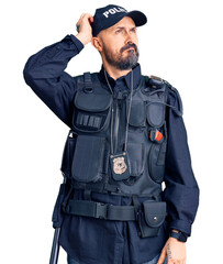 Young handsome man wearing police uniform confuse and wondering about question. uncertain with...