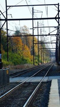 The railroad view with the parallel iron tracks and platform as background