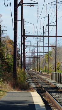 The railroad view with the parallel iron tracks and platform as background