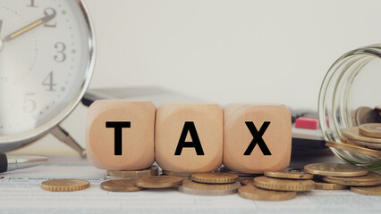 Tax wooden letter  on wooden block.Pay tax Income Statement. paying the tax rate. Taxation, taxes...