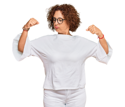 Beautiful middle age mature woman wearing casual clothes and glasses showing arms muscles smiling proud. fitness concept.