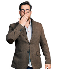 Young hispanic man wearing business jacket and glasses bored yawning tired covering mouth with...