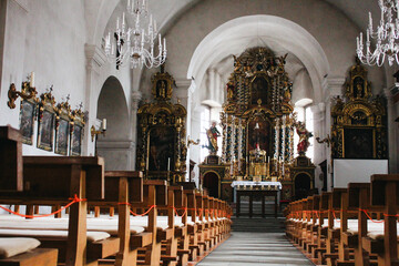 interior of a church with sculptural decorations gold and art on ceiling