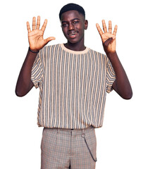 Young african american man wearing casual clothes showing and pointing up with fingers number nine...