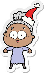 hand drawn sticker cartoon of a happy old woman wearing santa hat