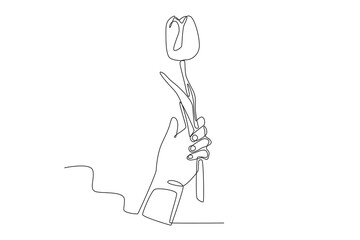 A hand holding a flower. Spring one-line drawing