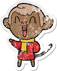distressed sticker of a cartoon laughing monkey