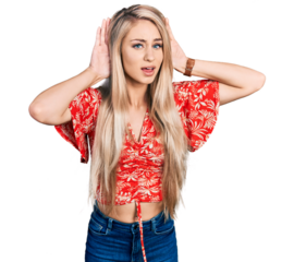 Beautiful young blonde woman wearing summer shirt trying to hear both hands on ear gesture, curious for gossip. hearing problem, deaf