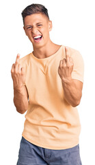 Young handsome man wearing casual clothes showing middle finger doing fuck you bad expression, provocation and rude attitude. screaming excited