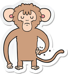 sticker of a cartoon monkey scratching