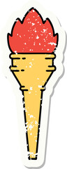 distressed sticker tattoo in traditional style of a lit torch
