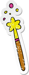 hand drawn distressed sticker cartoon doodle of a magic wand