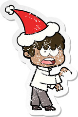 worried hand drawn distressed sticker cartoon of a boy wearing santa hat
