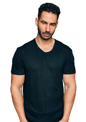 Fototapeta premium Hispanic man with beard wearing casual black t shirt depressed and worry for distress, crying angry and afraid. sad expression.