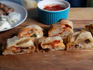 Side view of stromboli slices on butcher block surface