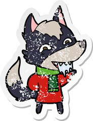 distressed sticker of a cartoon hungry wolf in winter clothes