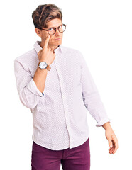 Young handsome man wearing business clothes and glasses pointing to the eye watching you gesture, suspicious expression