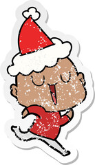 happy hand drawn distressed sticker cartoon of a bald man wearing santa hat