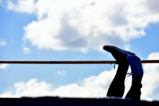 Feet in the air by a high jump athlete